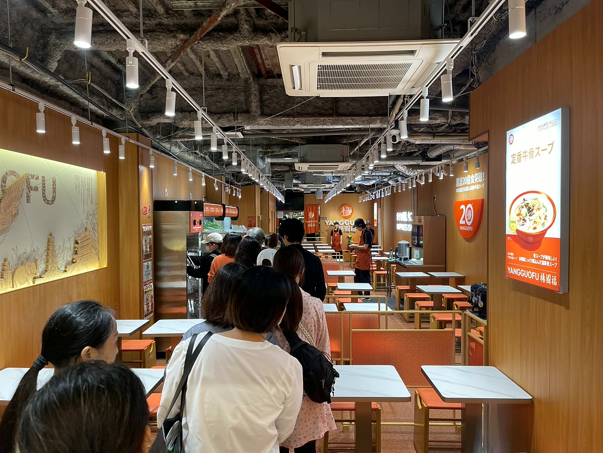 オレンジの差し色が映える広い店内と多くの客席